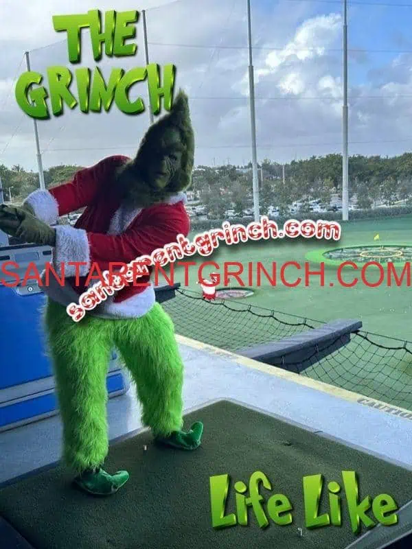 Grinch for Hire at Corporate Events - Santa Rent Grinch Grinch posing on a golf driving range tee with green netting and palm trees behind him